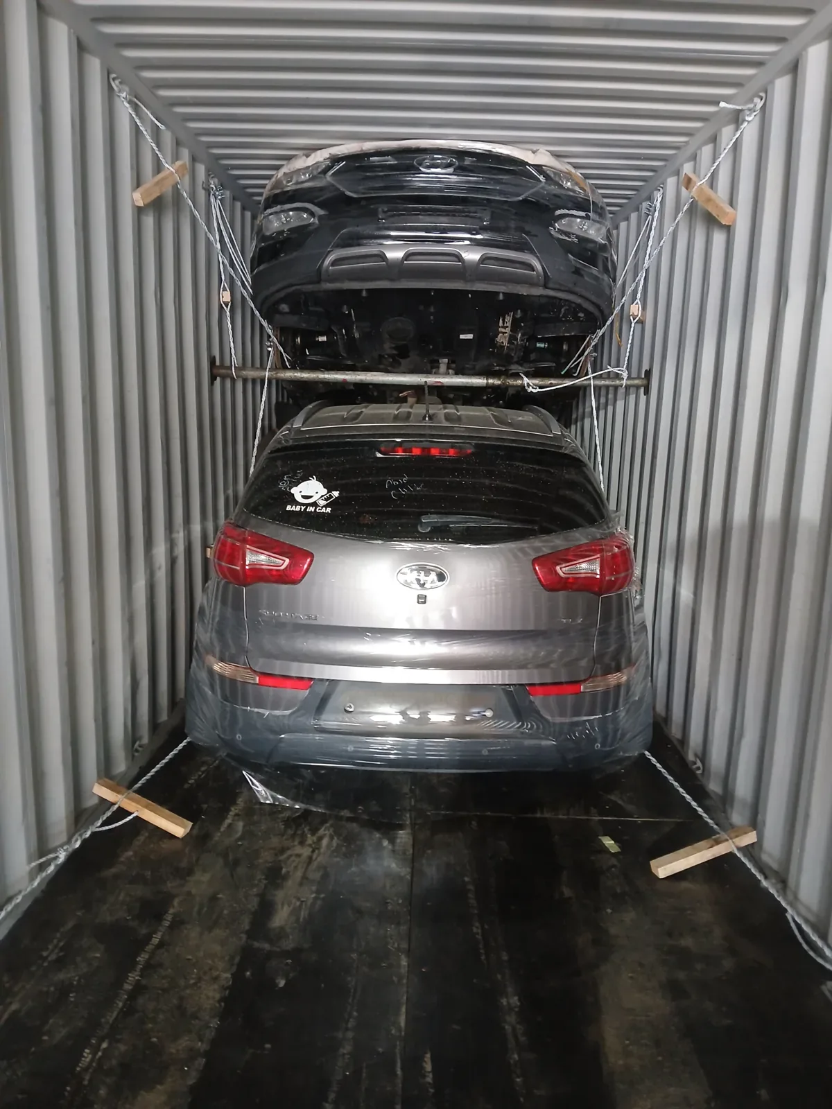 Two vehicles lashed in container
